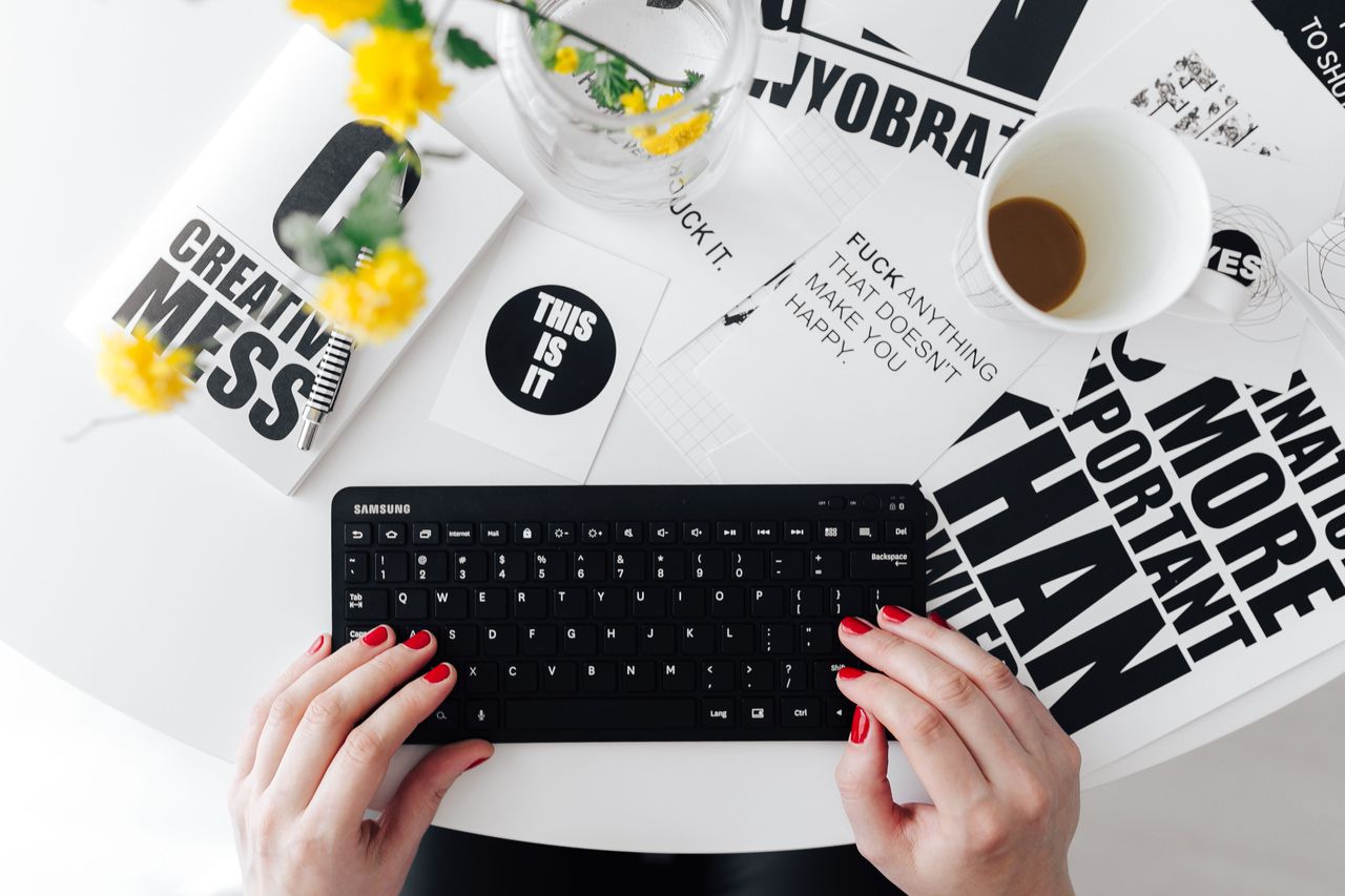 Female hands typing on the remote wireless computer keyboard