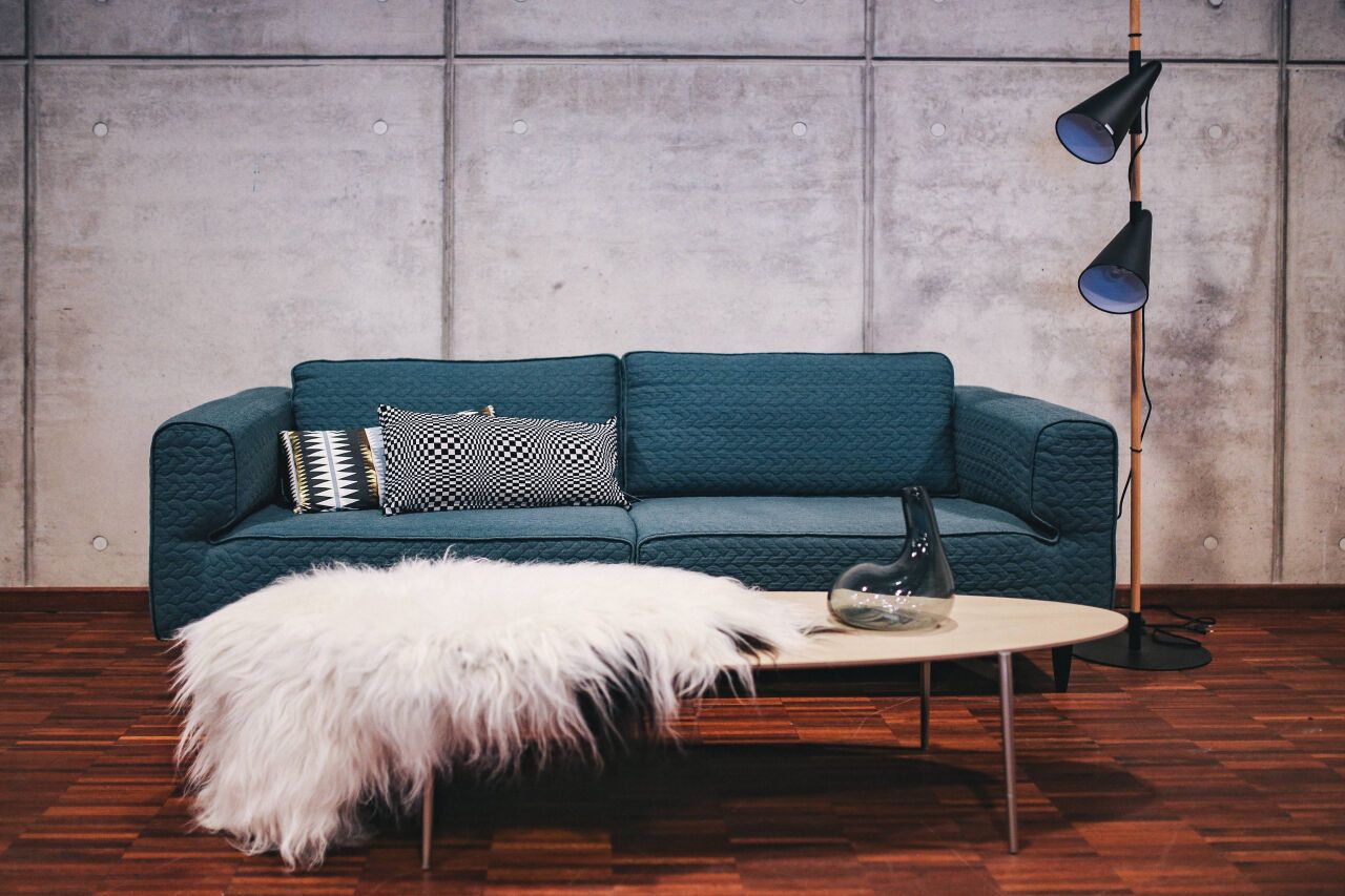 Blue sofa with pillows in a designer living room interior